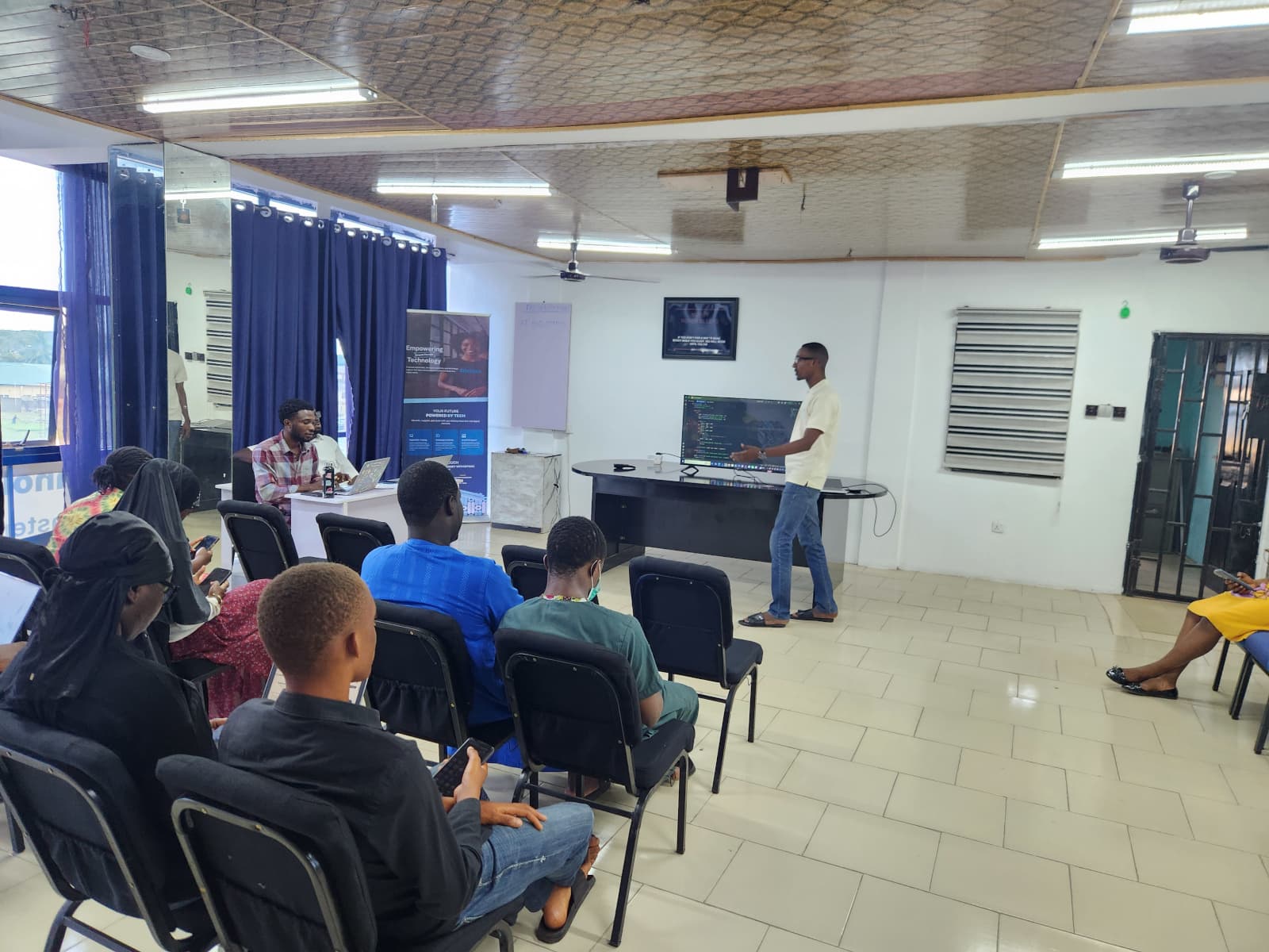An instructor walking a class through a data project on the wall-mounted screen.
