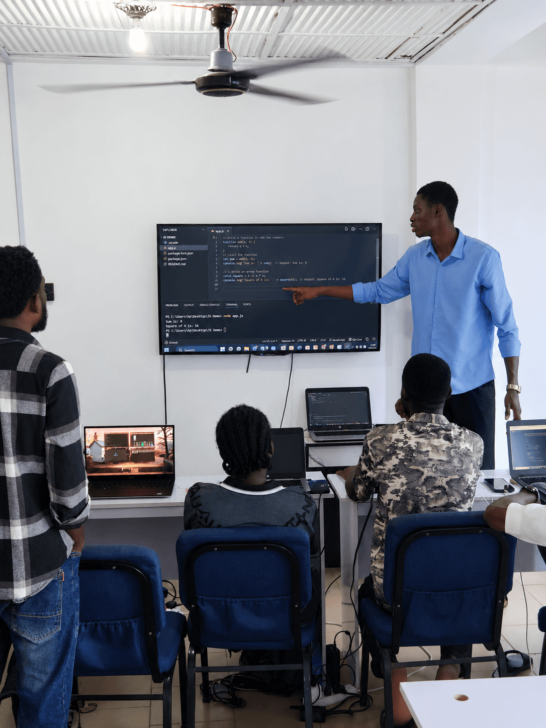 A Bitnox Technology instructor supporting a student during class at the Abeokuta training centre